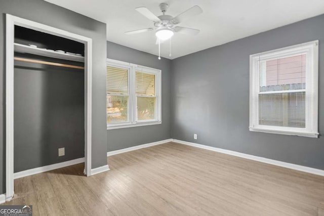391 Mount Zion Rd SW, Atlanta, GA 30354 - unfurnished bedroom with light wood-type flooring, ceiling fan, baseboards, and a closet