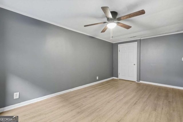 391 Mount Zion Rd SW, Atlanta, GA 30354 - spare room featuring crown molding, light wood finished floors, visible vents, a ceiling fan, and baseboards