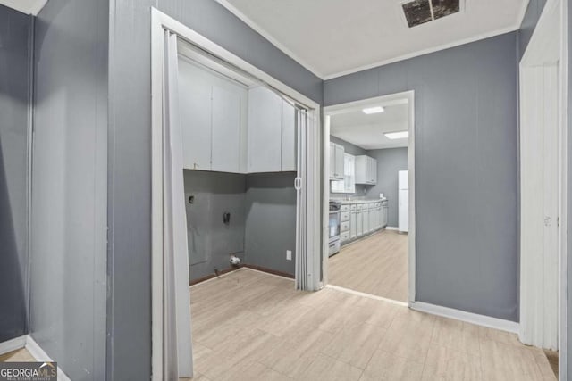 391 Mount Zion Rd SW, Atlanta, GA 30354 - washroom with crown molding, cabinet space, visible vents, light wood-type flooring, and baseboards