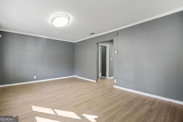 391 Mount Zion Rd SW, Atlanta, GA 30354 - empty room with light wood-type flooring, visible vents, baseboards, and crown molding
