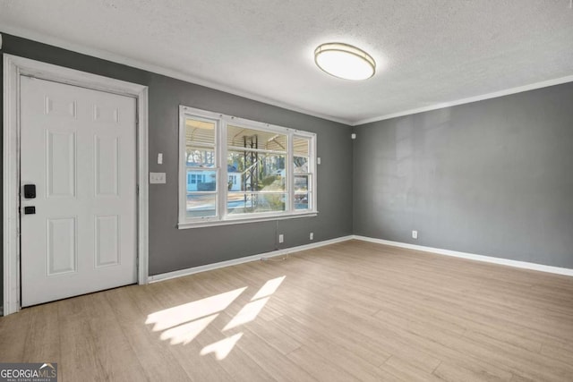 391 Mount Zion Rd SW, Atlanta, GA 30354 - foyer featuring ornamental molding, baseboards, a textured ceiling, and light wood finished floors