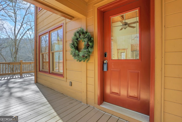 doorway to property featuring a ceiling fan