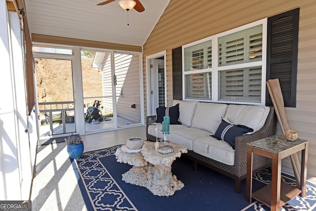 sunroom with ceiling fan and vaulted ceiling