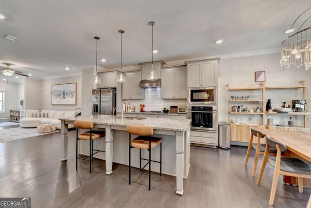 kitchen with stainless steel appliances, a breakfast bar, pendant lighting, and light stone counters