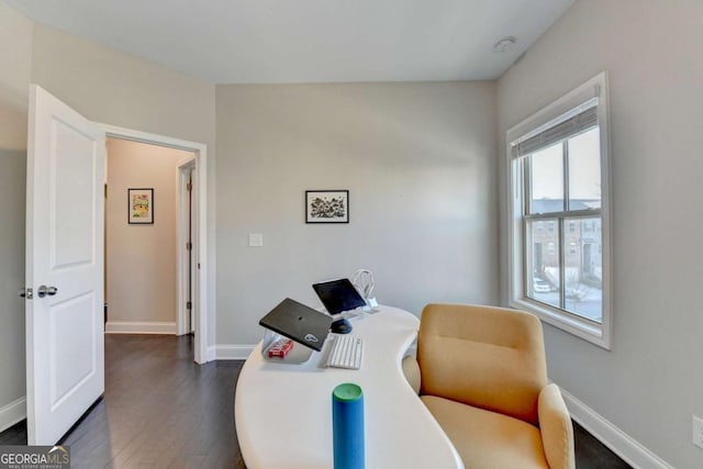 sitting room with dark wood-style flooring and baseboards