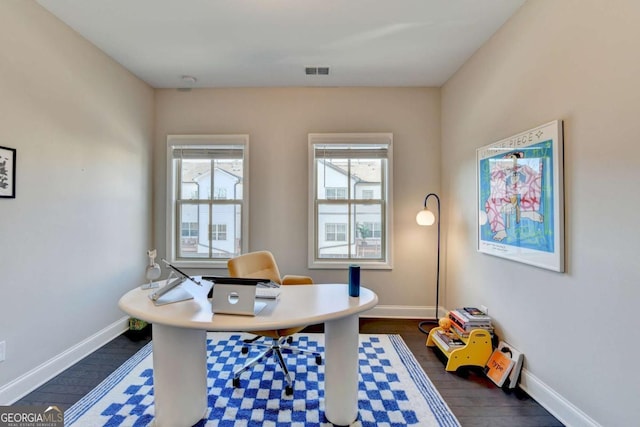 office featuring baseboards, visible vents, and dark wood finished floors