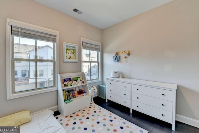 bedroom featuring dark wood-style flooring, visible vents, and baseboards