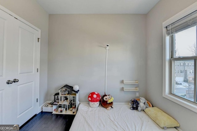 bedroom with dark wood finished floors