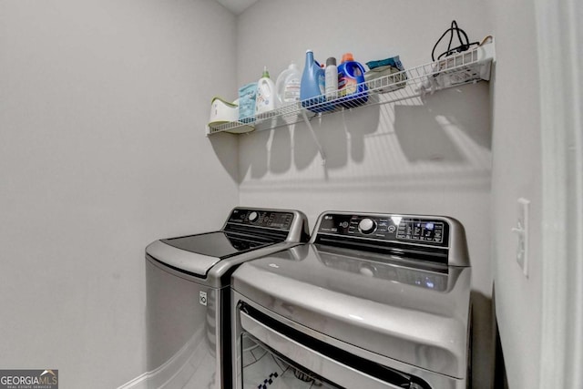 laundry room featuring laundry area, baseboards, and washer and dryer