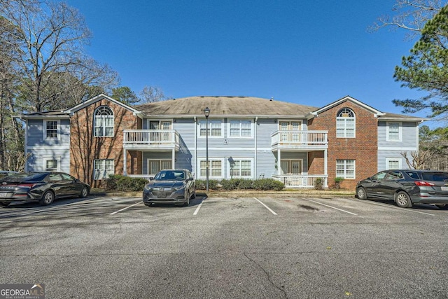 view of building exterior with uncovered parking