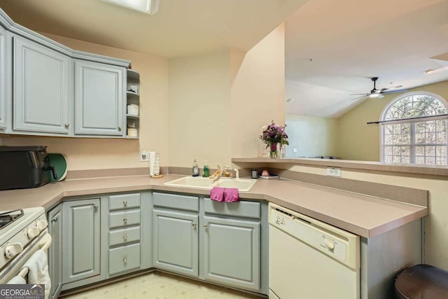 kitchen with white appliances, a peninsula, light countertops, light floors, and a sink