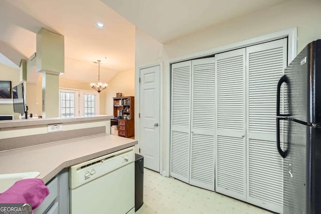 kitchen with vaulted ceiling, light countertops, freestanding refrigerator, dishwasher, and pendant lighting