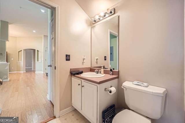 bathroom with vanity, toilet, and baseboards