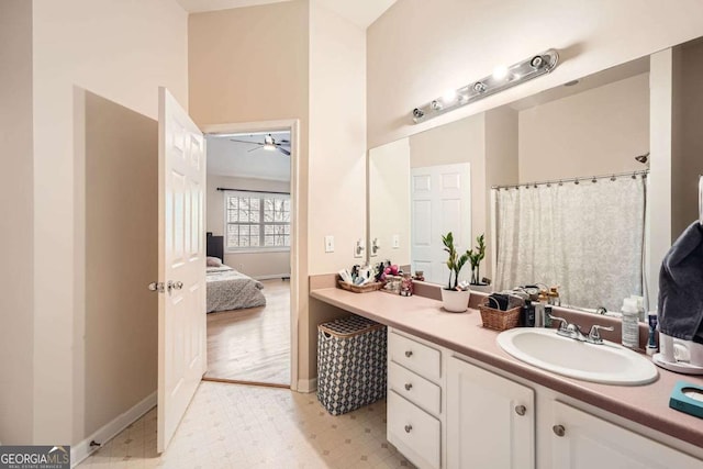 bathroom with tile patterned floors, vanity, baseboards, and ensuite bathroom