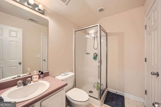 bathroom featuring visible vents, a shower stall, toilet, and vanity