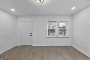 interior space with dark wood-style floors, recessed lighting, and baseboards