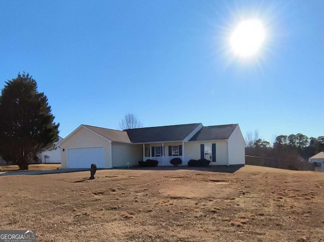 ranch-style house featuring a garage and a porch