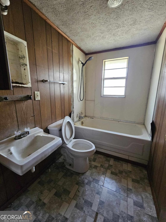 full bath featuring wood walls, a sink, and shower / bathing tub combination