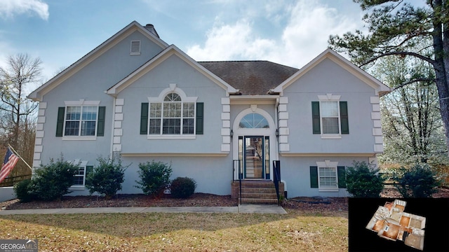 bi-level home featuring stucco siding