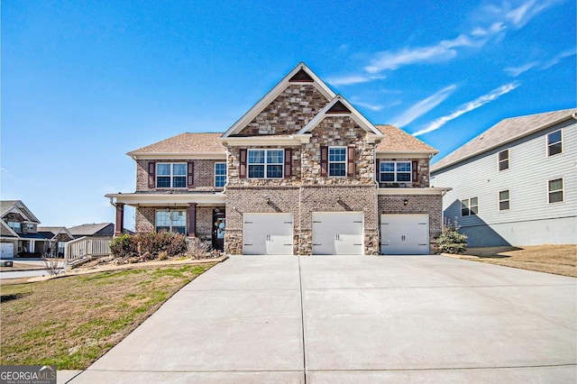 craftsman-style house with brick siding, concrete driveway, a garage, stone siding, and a front lawn