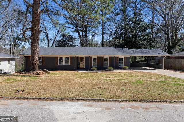 ranch-style house with a carport, a front yard, and driveway