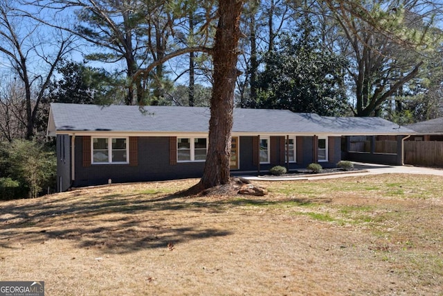 ranch-style home with brick siding and a front yard