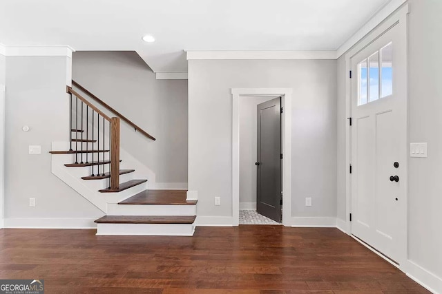 entryway with baseboards, ornamental molding, dark wood-type flooring, stairs, and recessed lighting