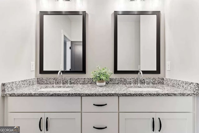 full bathroom featuring a sink and double vanity