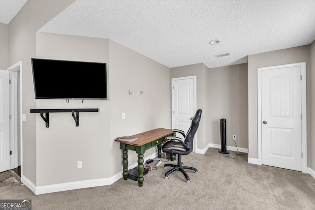 office area featuring light carpet, a textured ceiling, visible vents, and baseboards