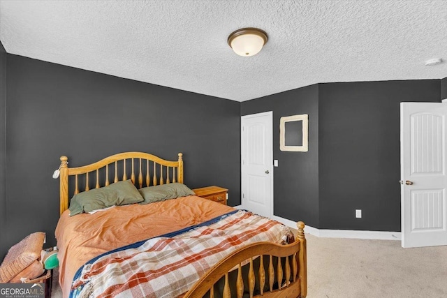 carpeted bedroom featuring baseboards and a textured ceiling