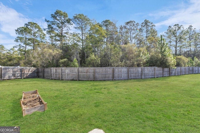 view of yard with fence private yard and a garden