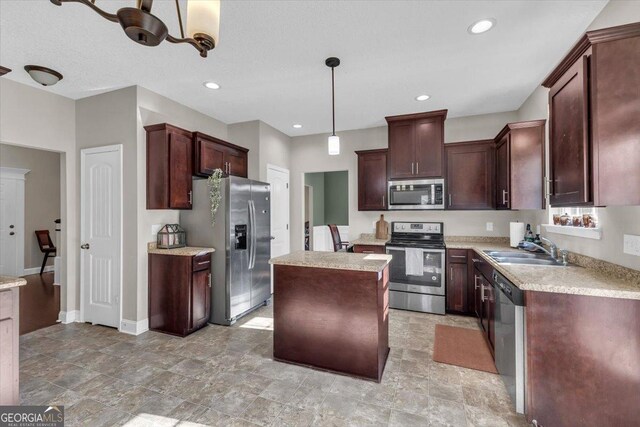 732 Waterlily Ct, Hinesville, GA 31313 - kitchen featuring stainless steel appliances, a kitchen island, light countertops, a sink, and pendant lighting