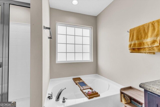 732 Waterlily Ct, Hinesville, GA 31313 - bathroom featuring a healthy amount of sunlight, a bath, and vanity