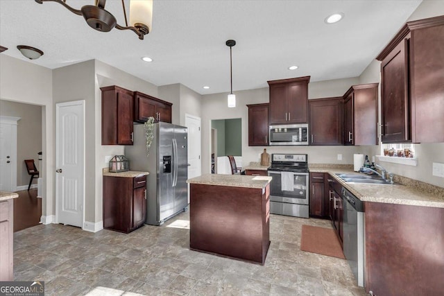 kitchen with stainless steel appliances, a center island, light countertops, and hanging light fixtures