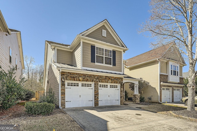 view of front of home featuring a garage, stone siding, and concrete driveway