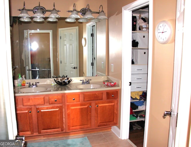 bathroom featuring double vanity, tile patterned flooring, and a sink