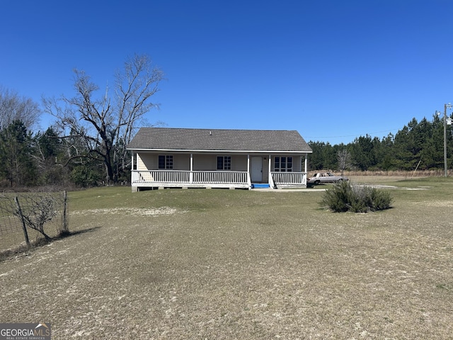 view of front of property with covered porch, driveway, and a front lawn