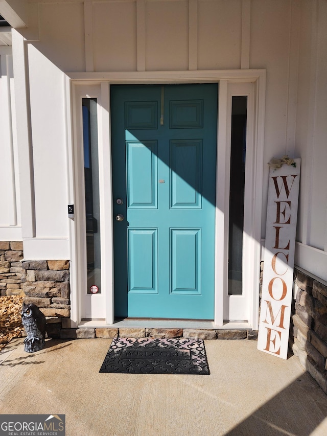 property entrance featuring stone siding