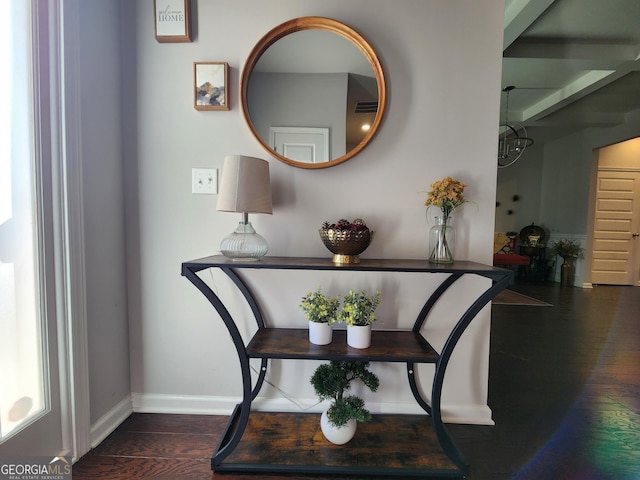 interior space with visible vents, baseboards, and wood finished floors