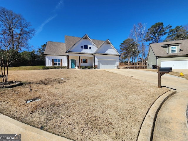 modern farmhouse with board and batten siding, an attached garage, and concrete driveway