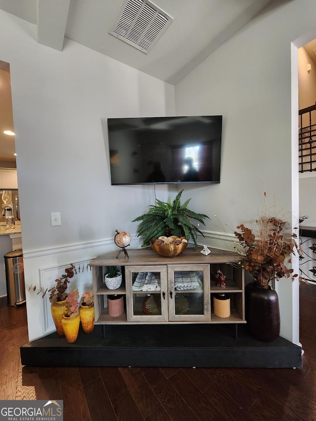 room details featuring visible vents and wood finished floors