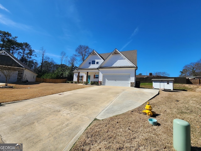 view of front of property featuring a garage, fence, a front lawn, and concrete driveway