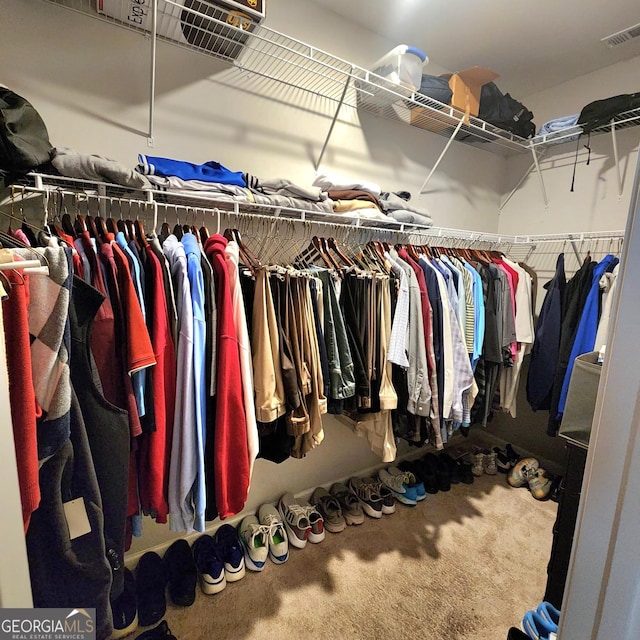 spacious closet with visible vents and carpet flooring