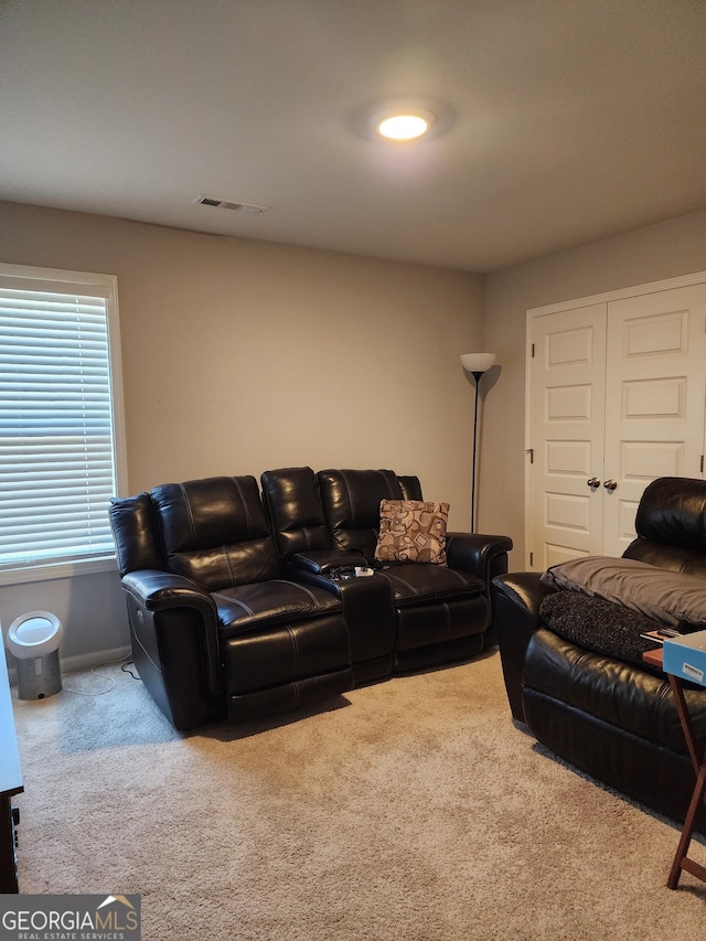 living room featuring carpet and visible vents