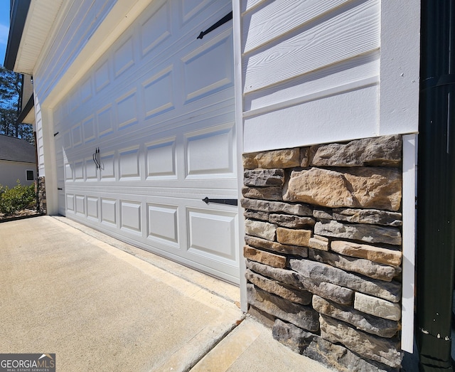 garage featuring concrete driveway