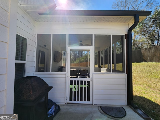 view of exterior entry with fence