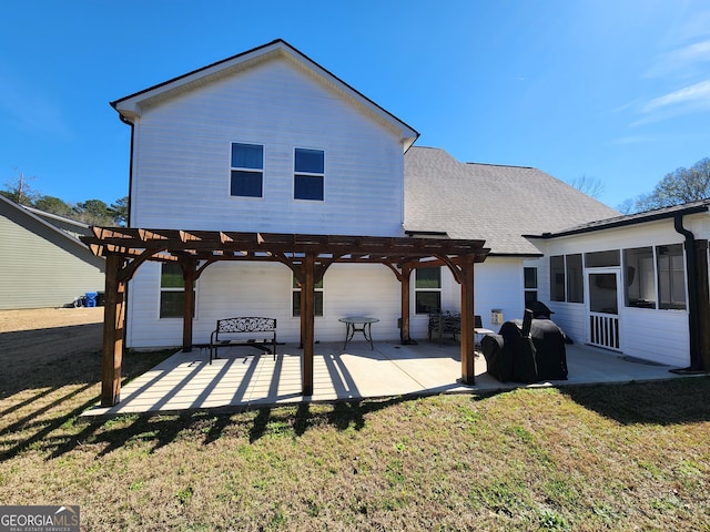 back of house featuring a patio area, a shingled roof, a lawn, and a pergola