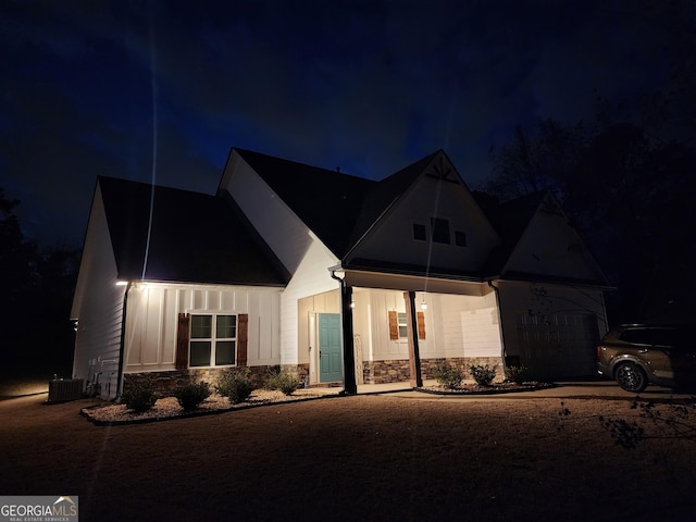 modern farmhouse with stone siding and board and batten siding