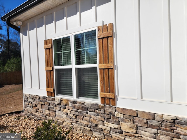 view of side of home featuring stone siding and board and batten siding