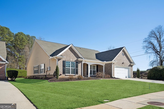 view of front of home featuring brick siding, roof with shingles, an attached garage, a front yard, and driveway